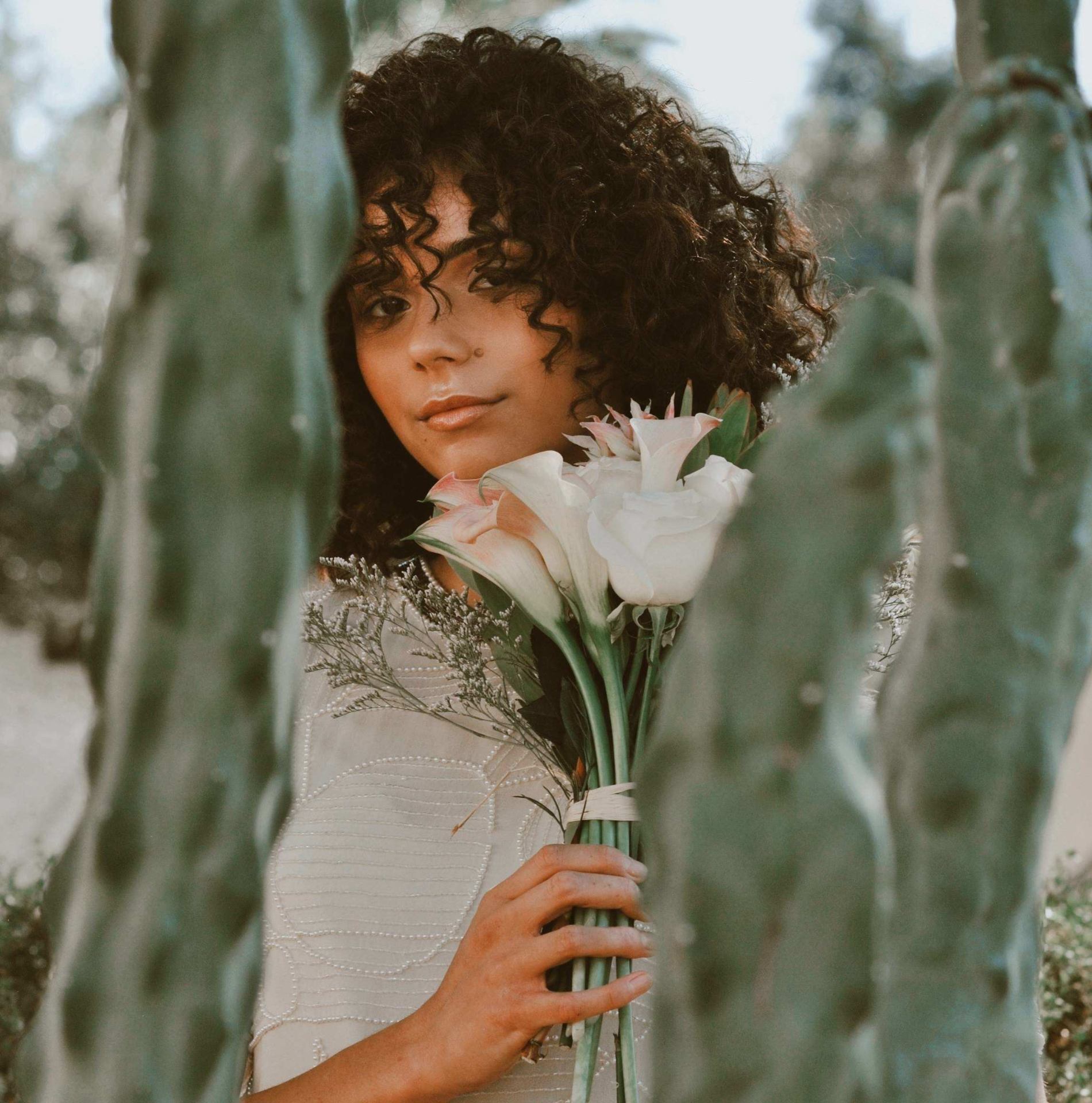 Portrait with white blooms among desert cactus