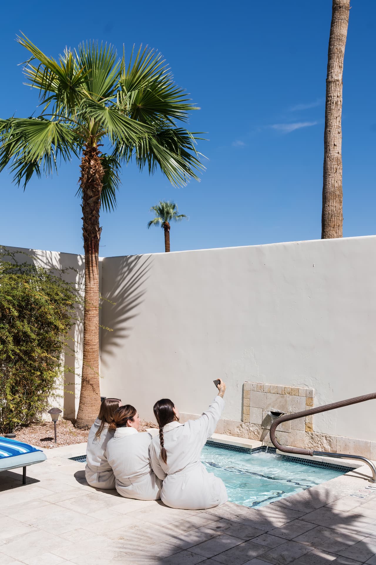Guests in robes relaxing beside a private plunge pool