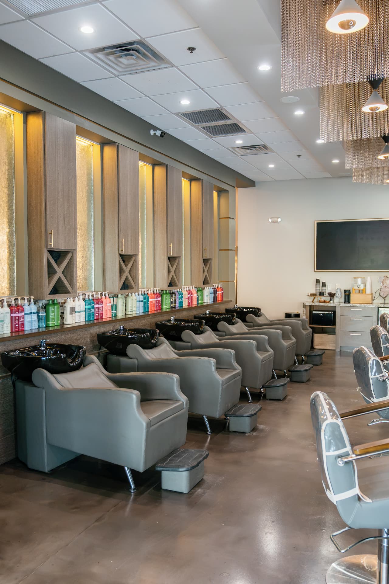 Row of shampoo bowls and backwash chairs at the Scottsdale salon