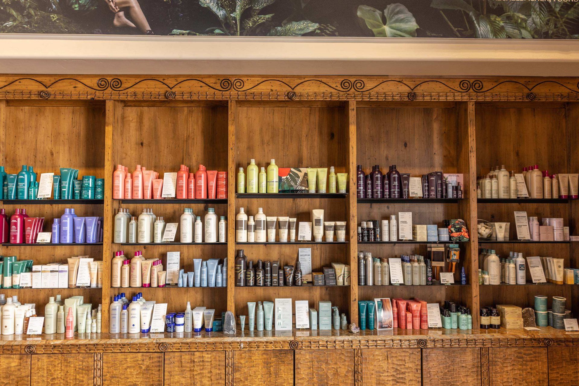 Aveda plant-powered products displayed on wooden shelves